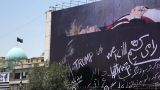 В гробу и белых тапках: в центре Тегерана появился плакат с Трампом